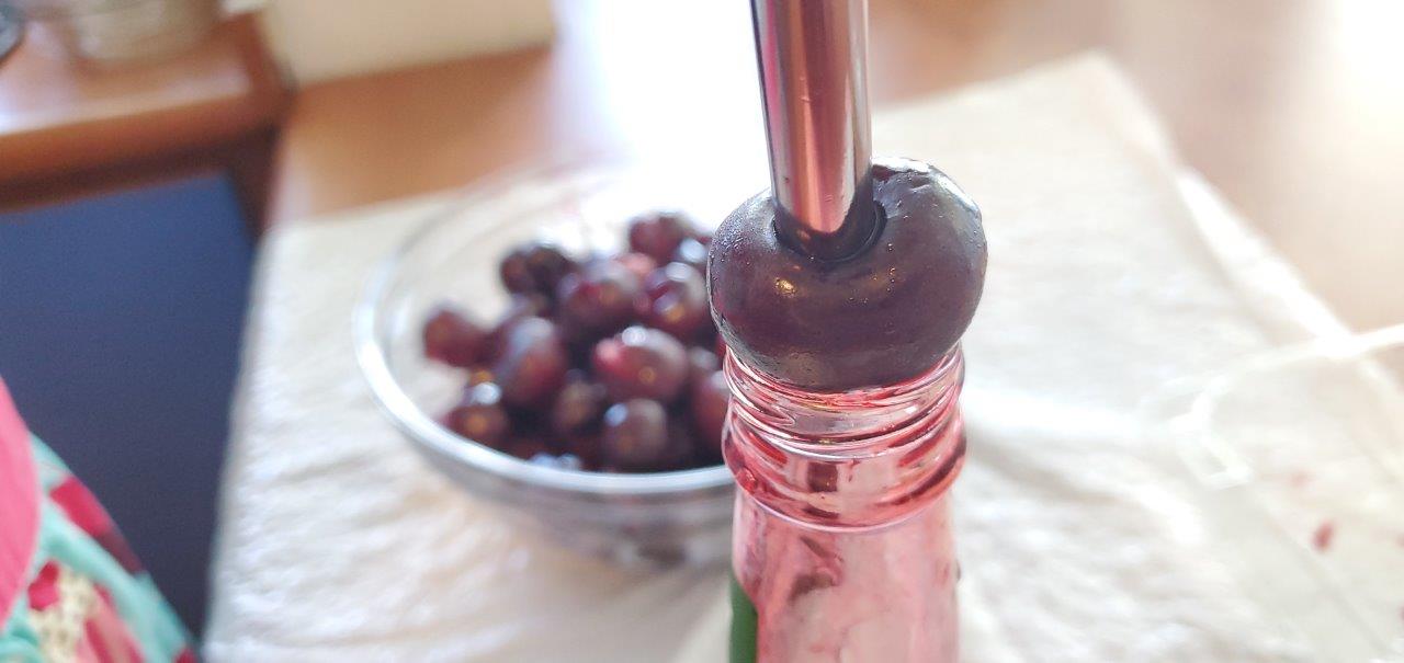 Using a metal straw and a bottle. Push to pit into the bottle